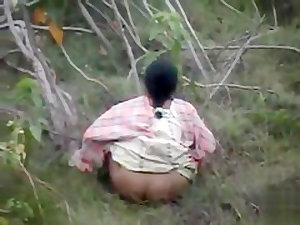 Indian women pissing in the grass in voyeur video